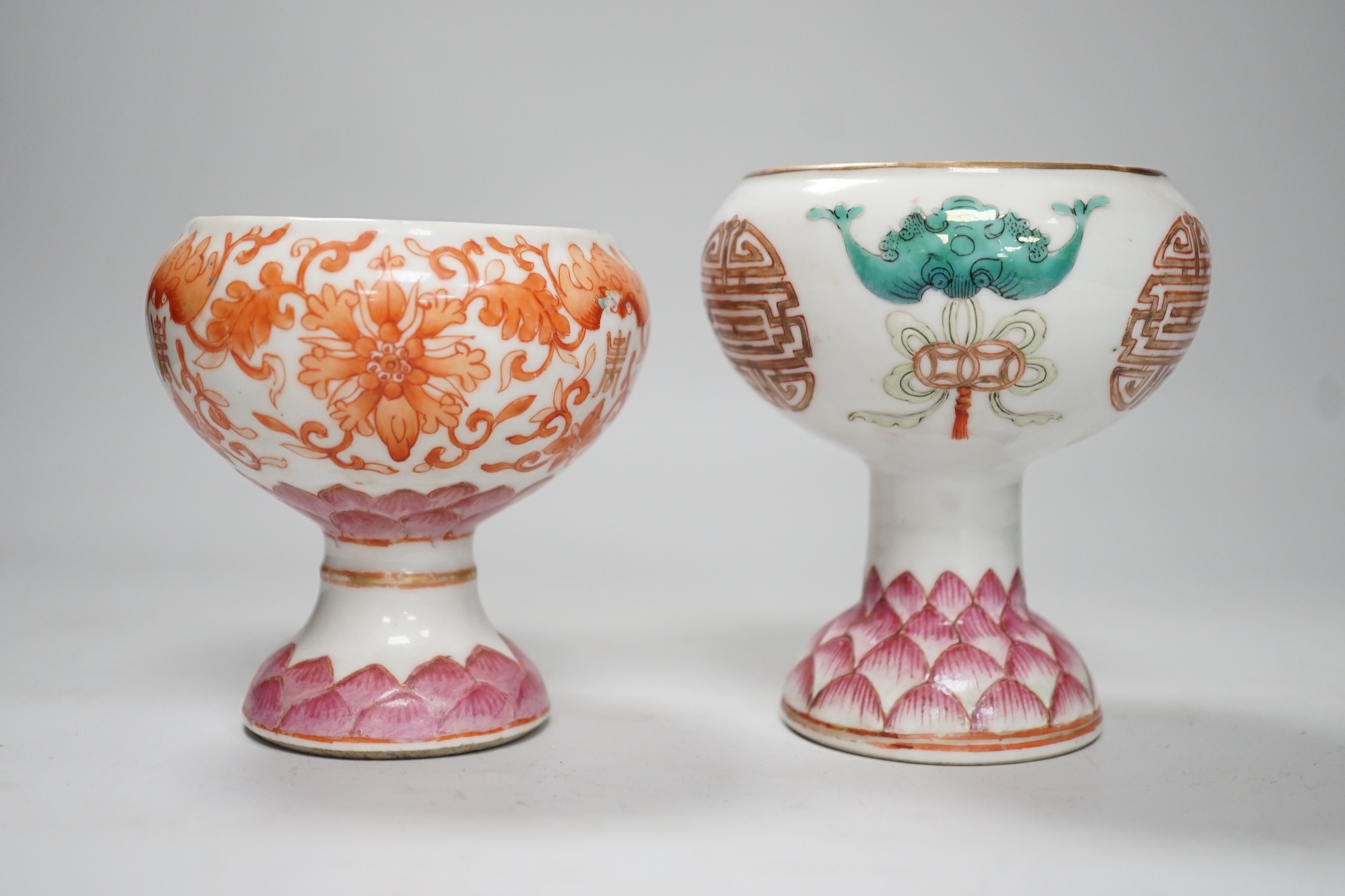 Two 19th century Chinese enamelled porcelain stem bowls, each painted with bats and Shou, the foot with Lotus petals, tallest 11cm